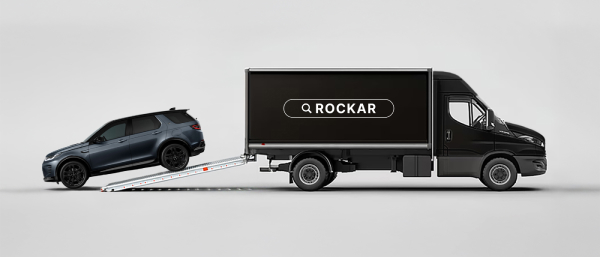 Side view of a Rockar delivery truck with a Discovery Sport being delivered from the back.