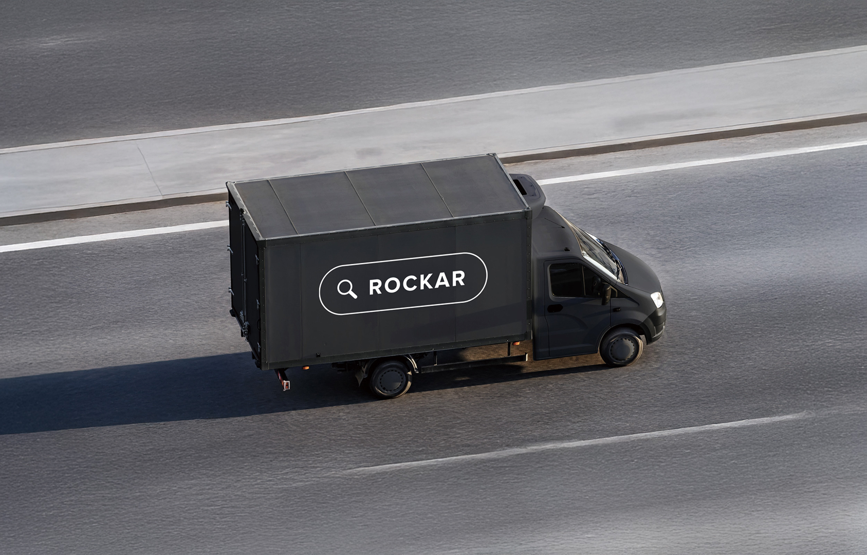 Rockar delivery truck driving along a road.