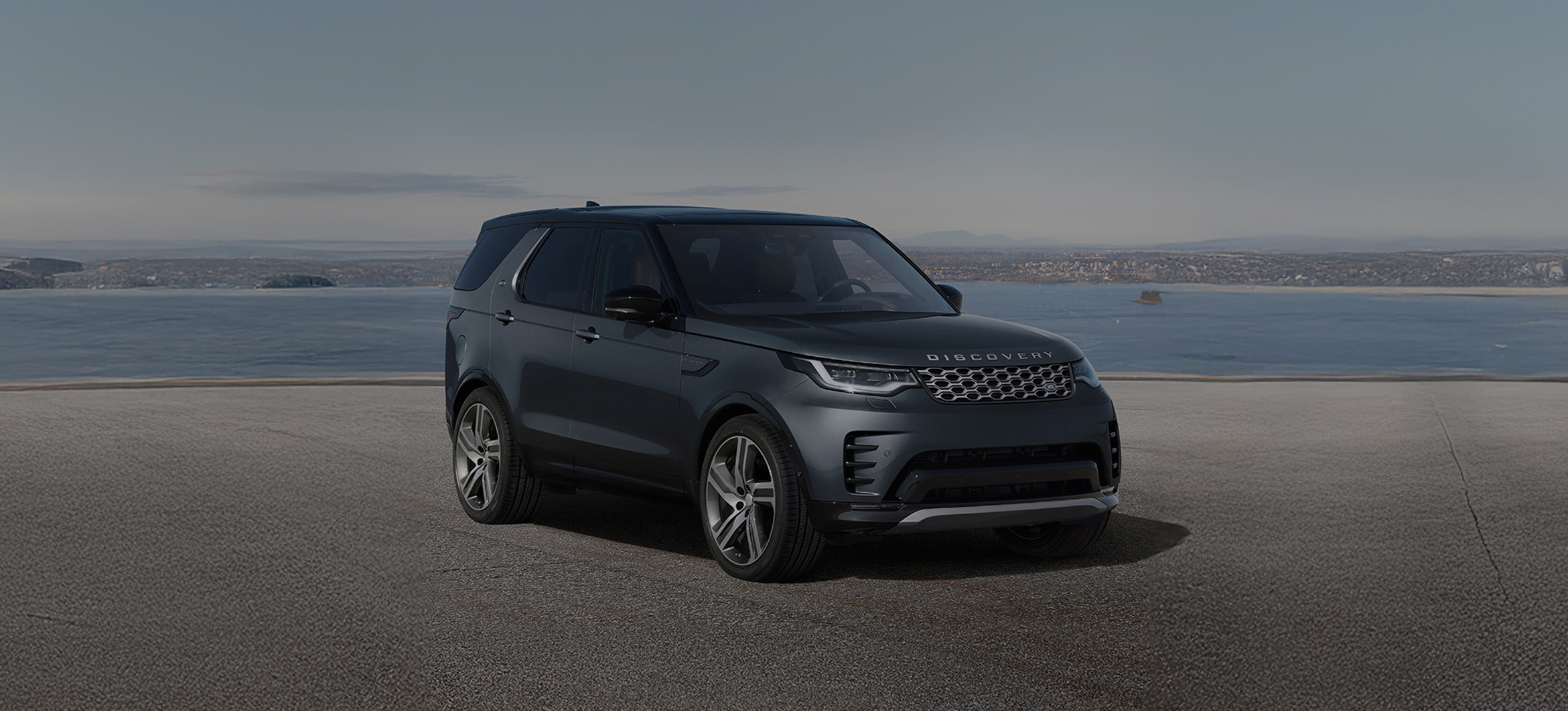 Front view of a Discovery, driving with promotional text overlay.
