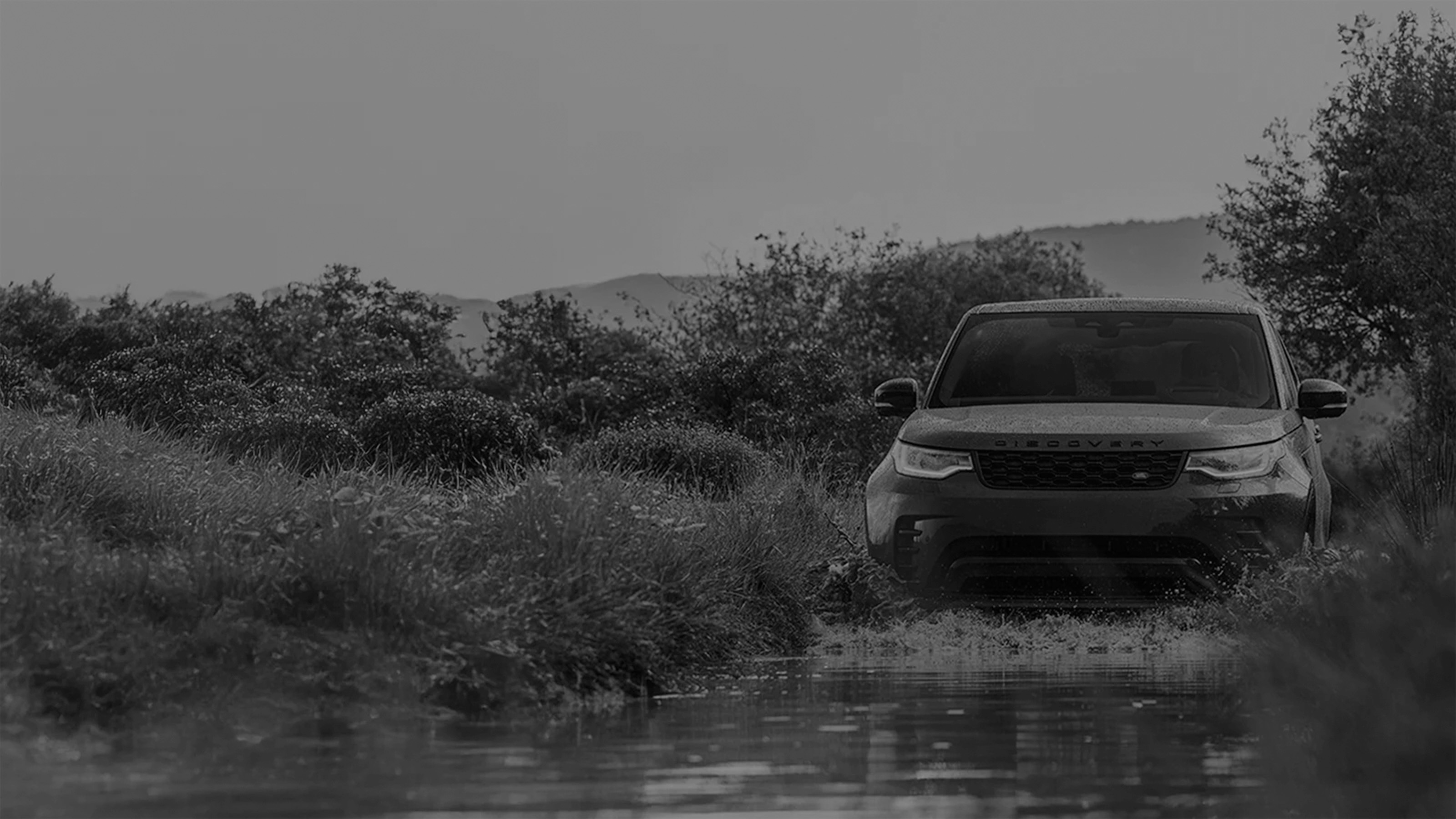 Front view of a Discovery, driving with promotional text overlay.