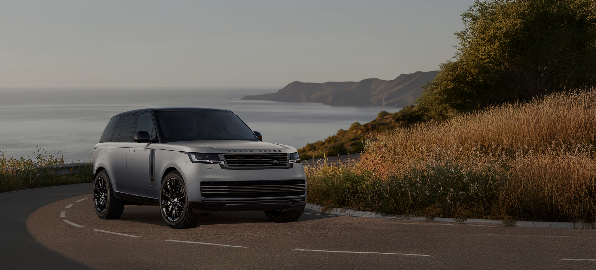 Side view of a Range Rover with promotional text overlay.