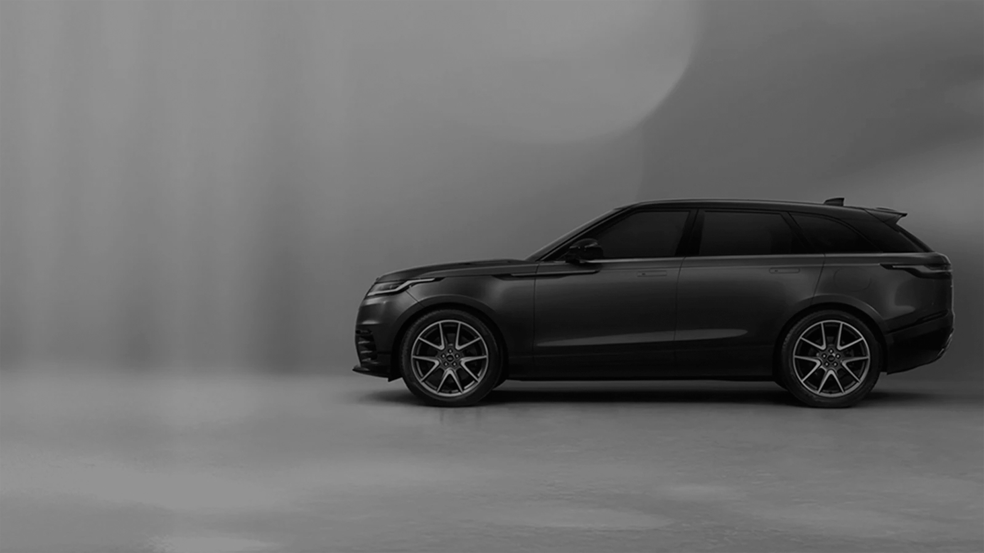 Side view of a Velar with promotional text overlay.