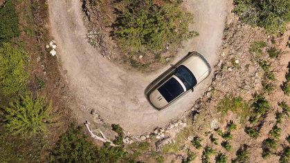 Range Rover driving on a winding dirt trail